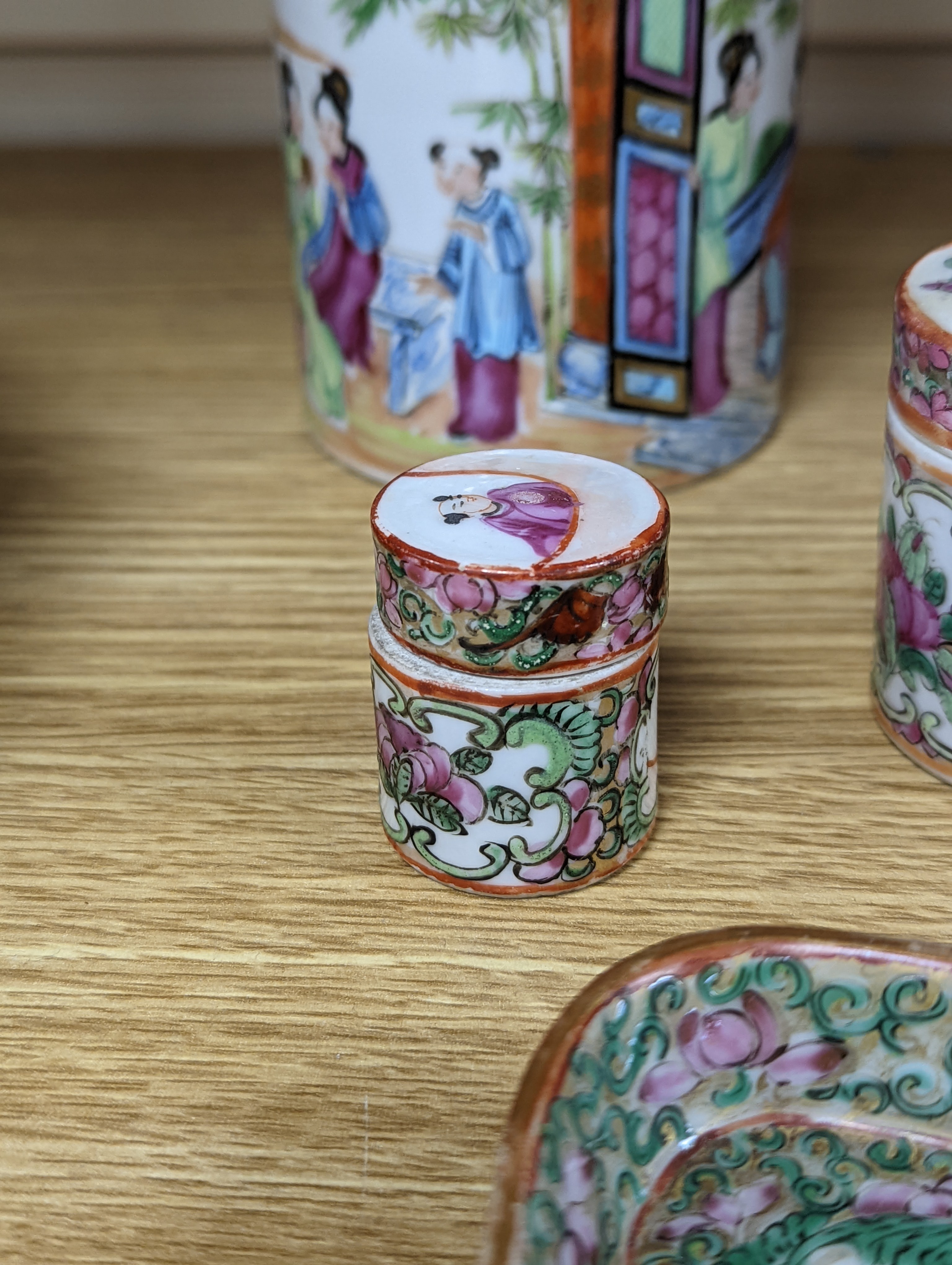 A Chinese Canton famille rose nest of boxes and covers, a similar candlestick and a tray 23cm
